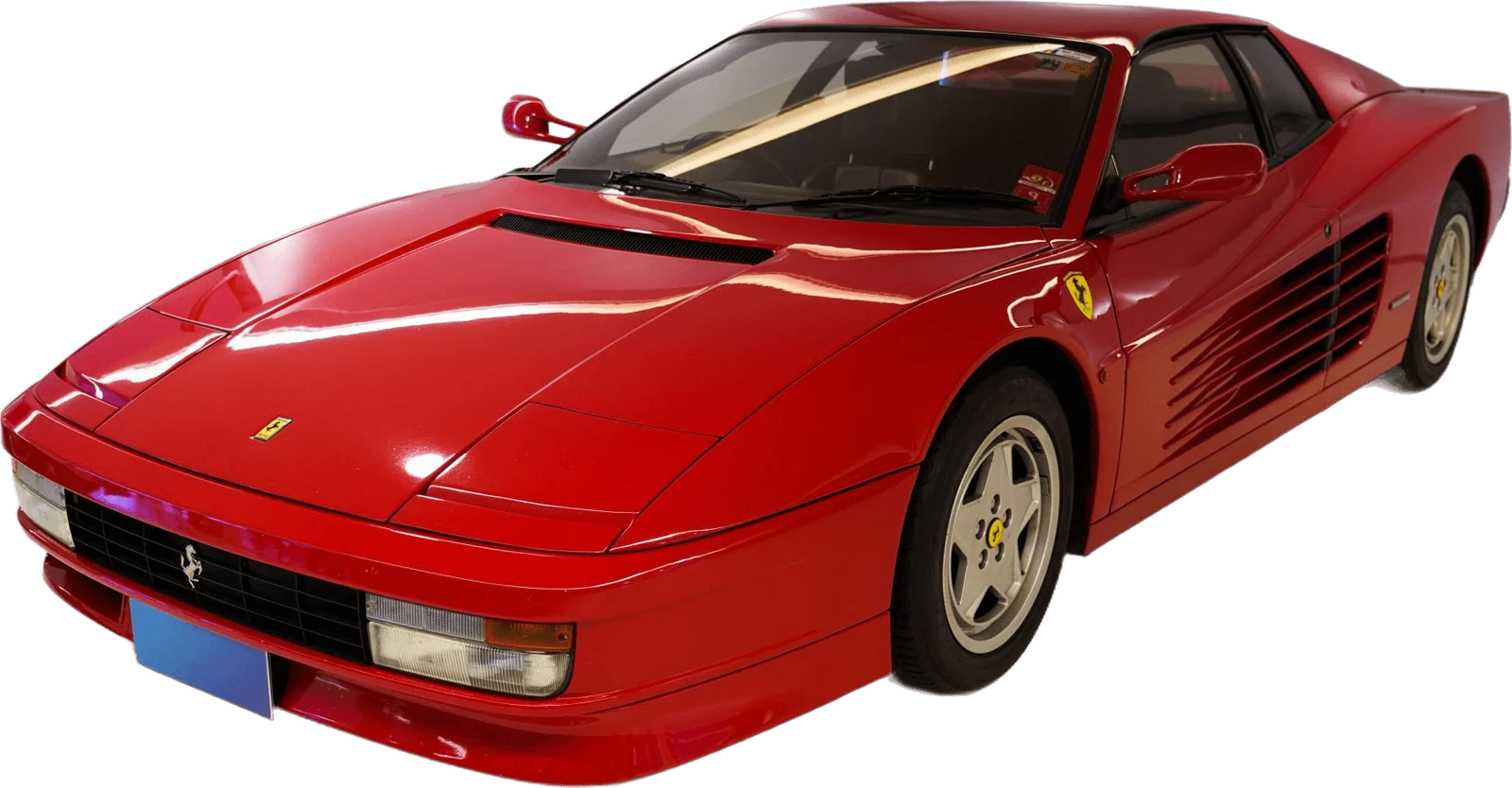 Red supercar parked at a three-quarter angle